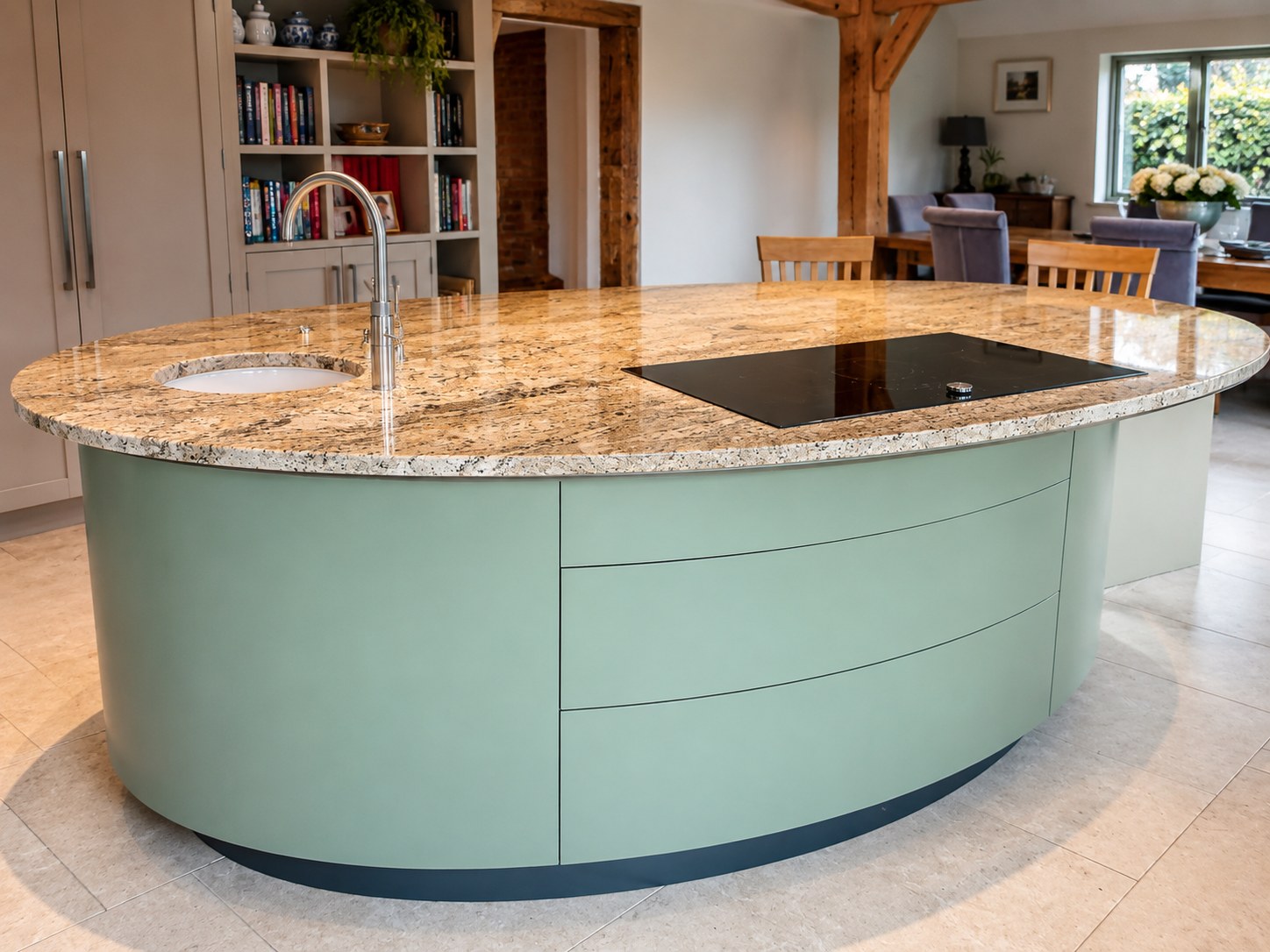 Curved painted kitchen island with a stone worktop