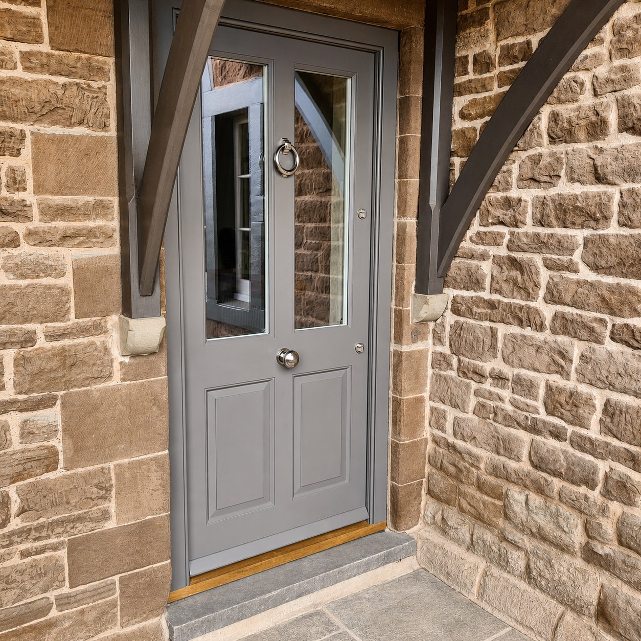 Grey double entrance doors in a stone opening
