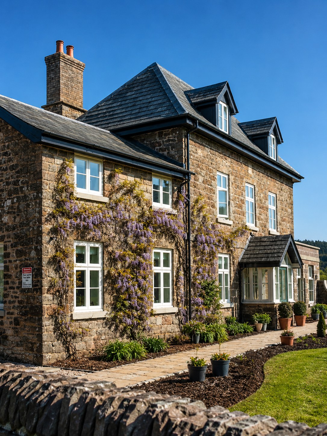 Stone house with painted windows and a glazed entrance