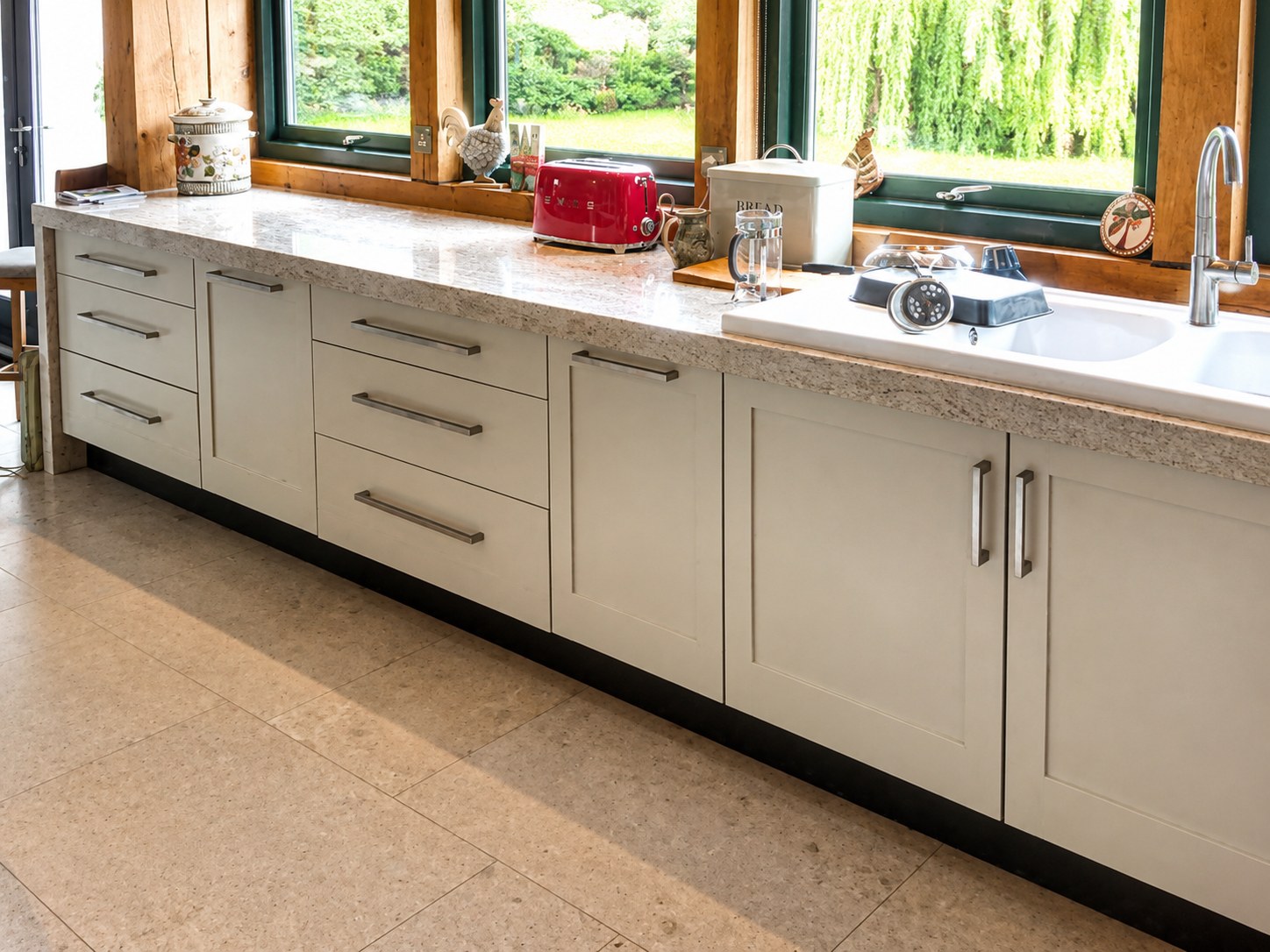Painted kitchen base cabinets below timber windows