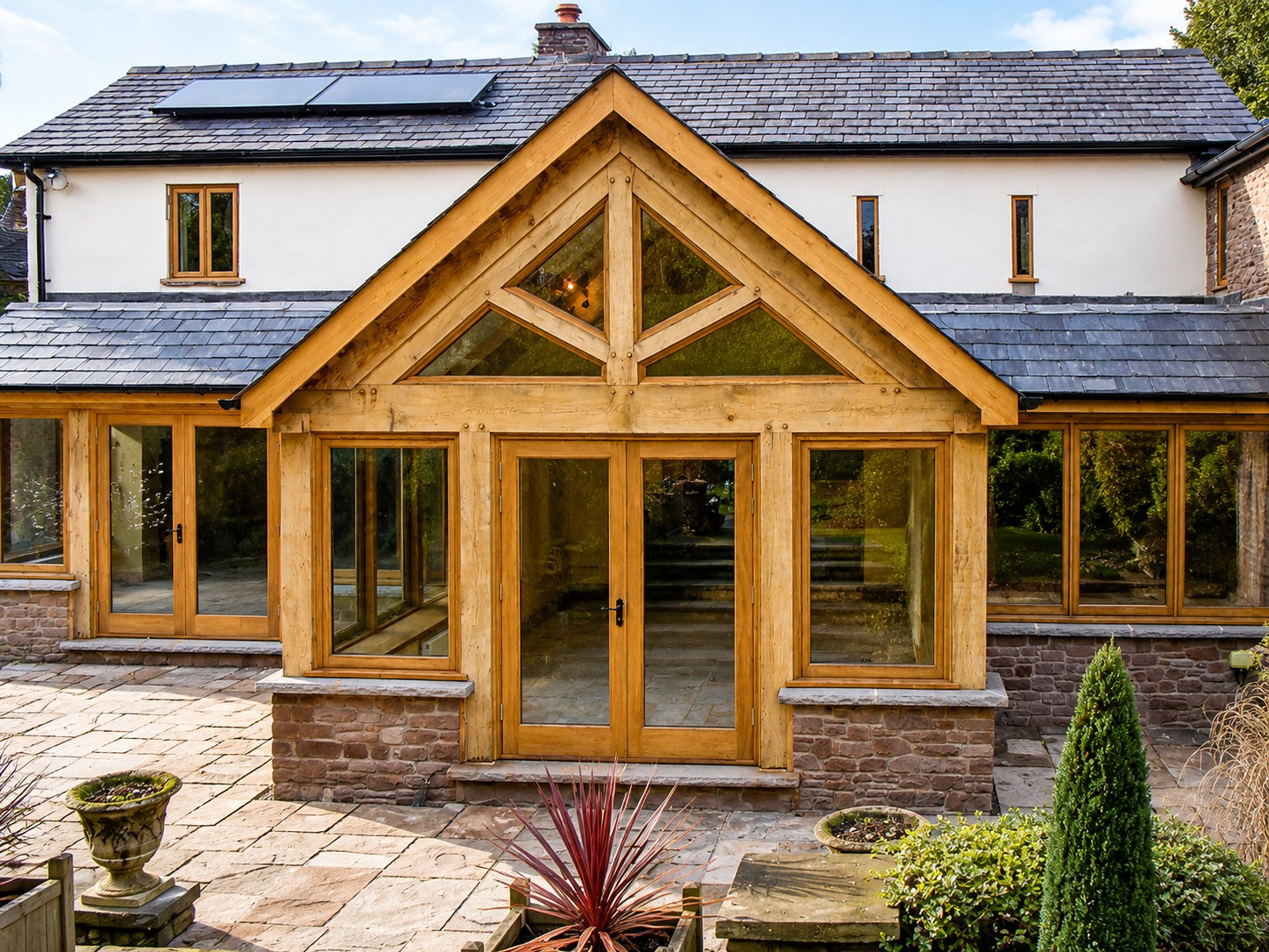 Timber garden room with glazed doors and gabled entrance