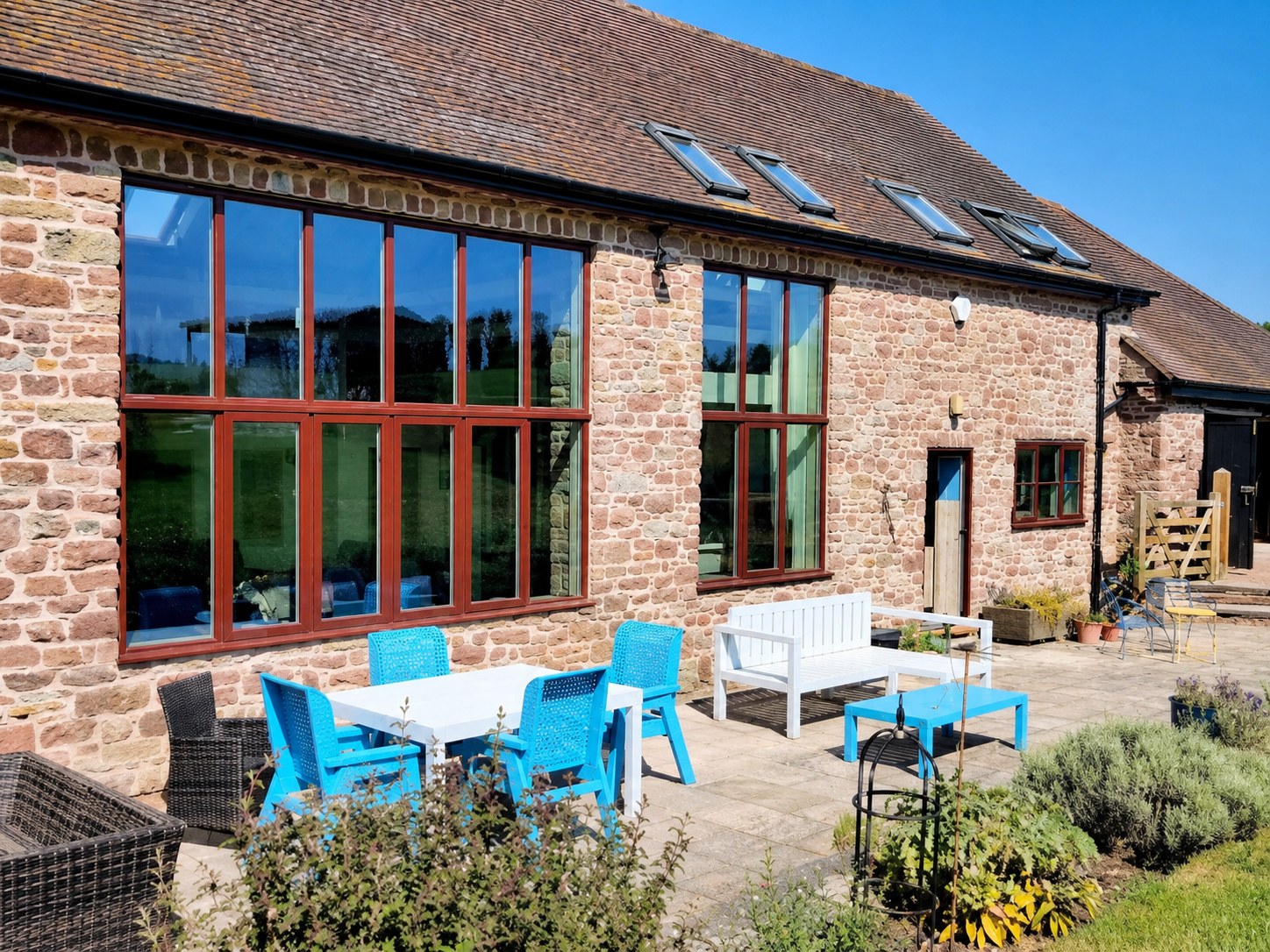 Full-height timber glazing across a barn elevation