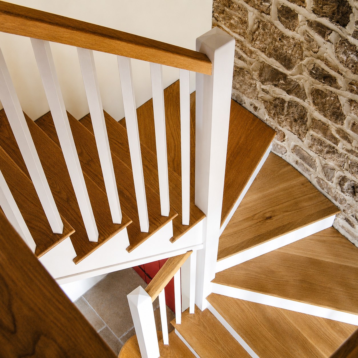 Turning staircase with white balusters and timber treads