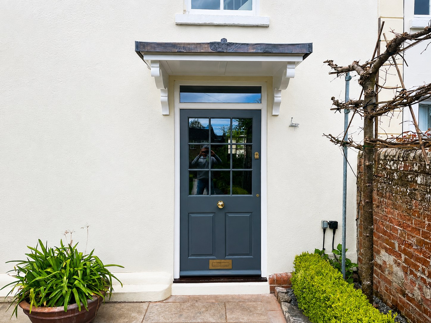 Dark painted entrance door in a pale door surround