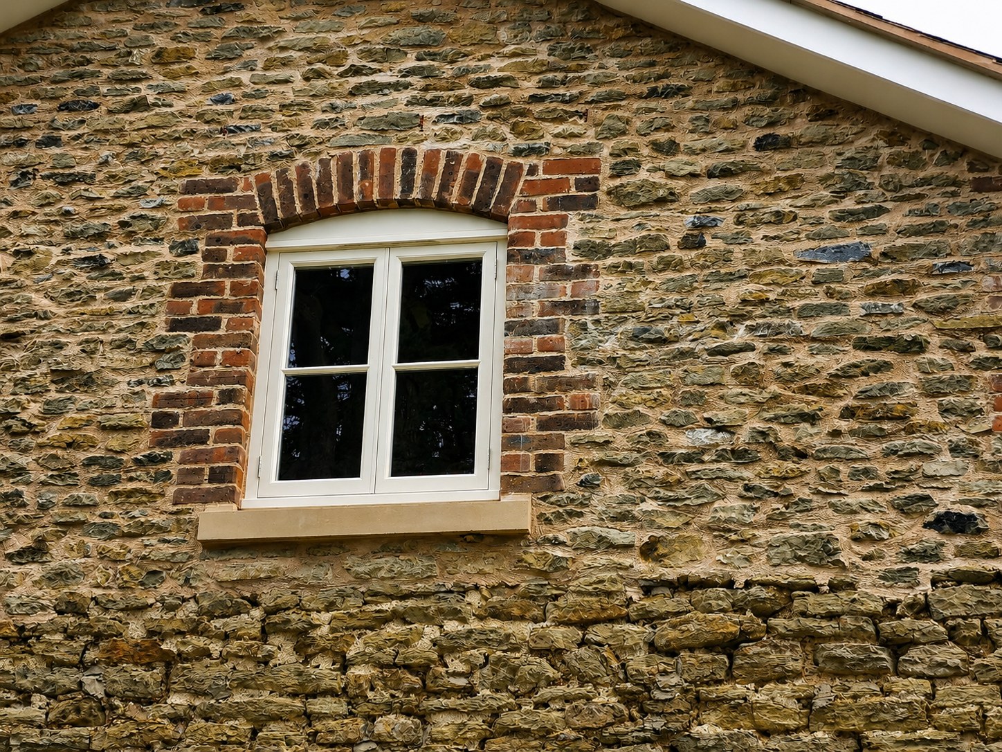 White casement window with a stone sill