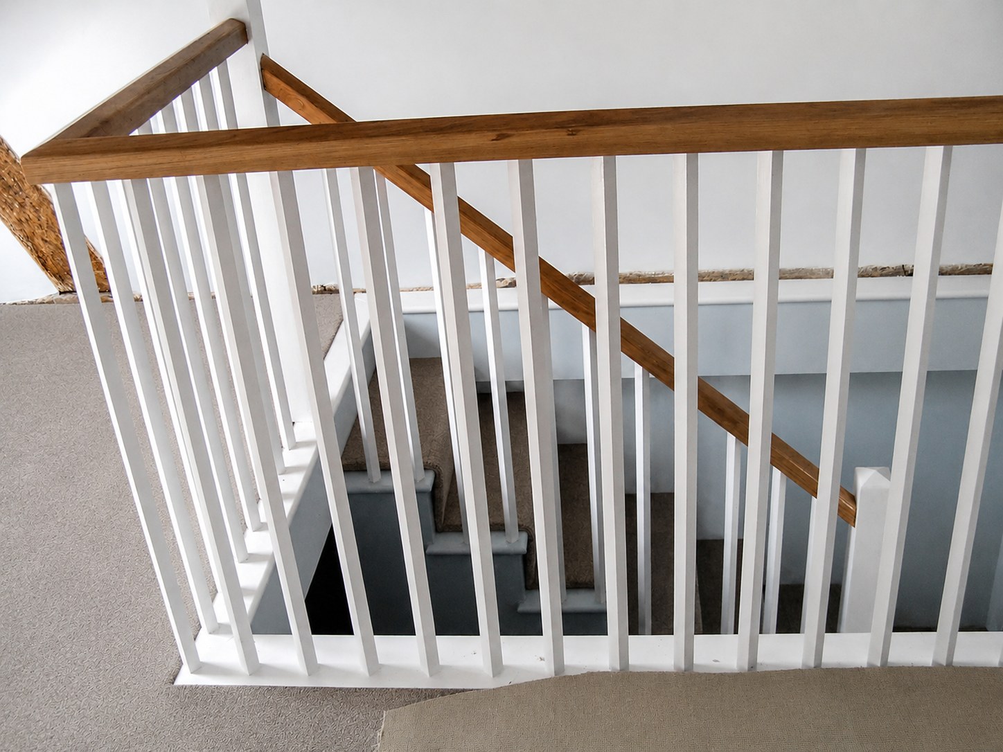Timber handrail and white stair balustrade