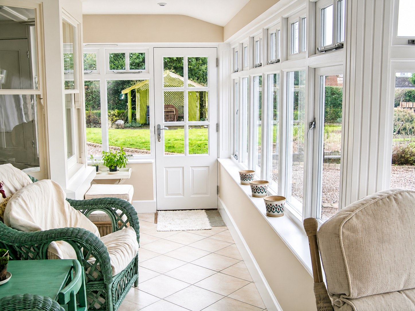 Inside a painted conservatory overlooking the garden