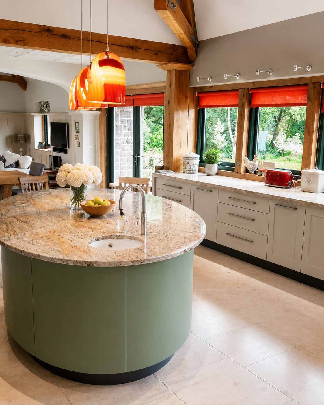 Kitchen island and cabinets beneath a garden-facing window