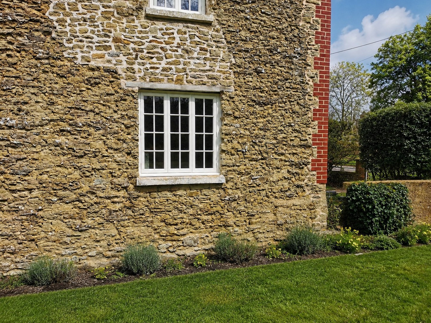 Divided-light timber window in a stone wall