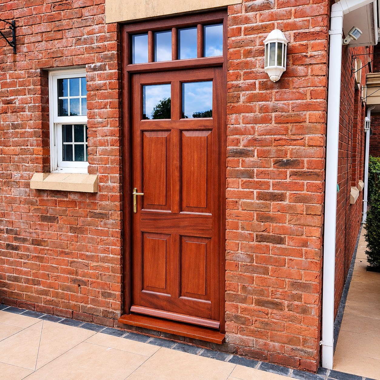 Panelled timber entrance door beside a brick path