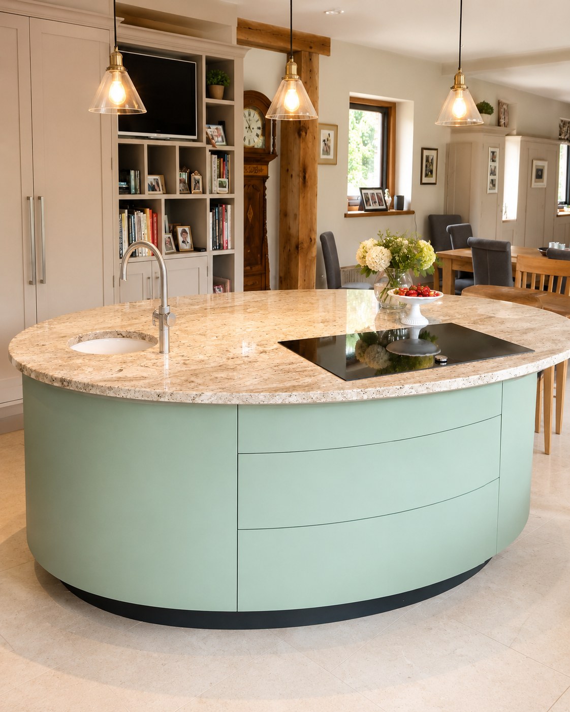 Curved kitchen island with cupboards and shelving beyond