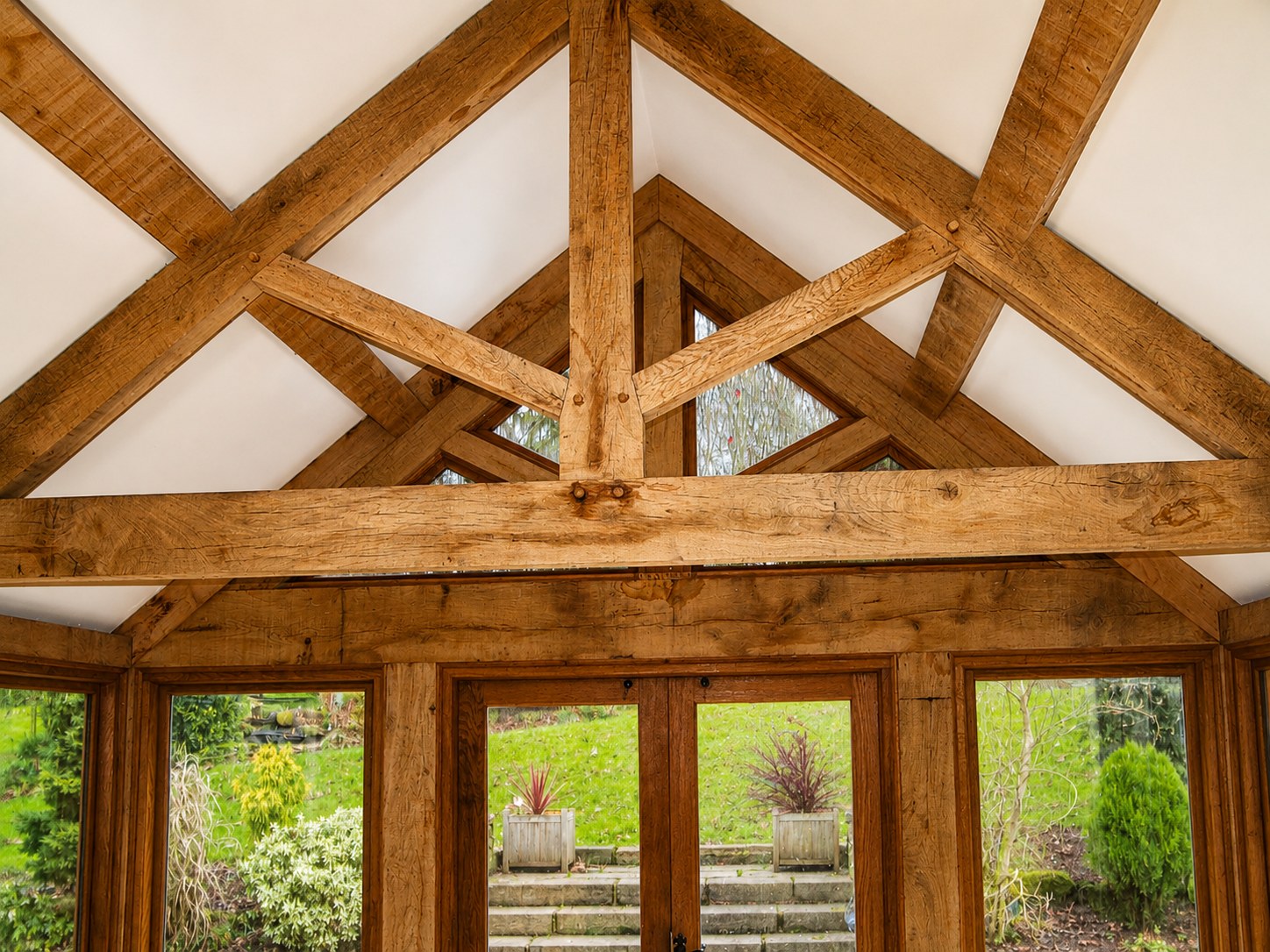 Exposed timber trusses above garden-room doors
