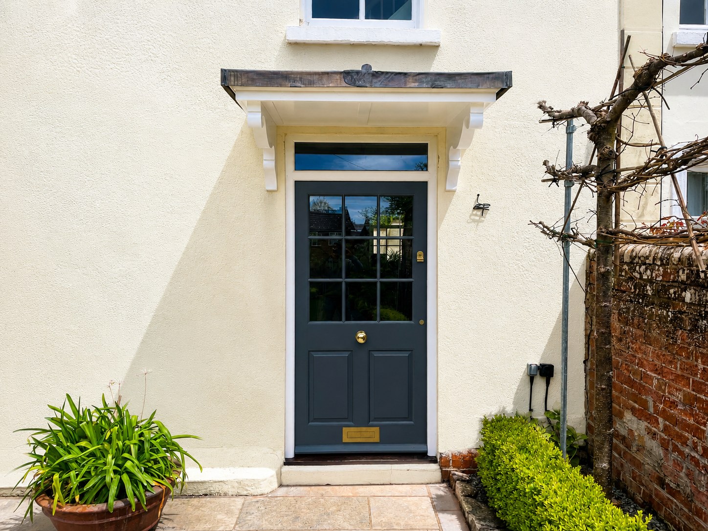 Dark painted front door and pale architectural surround