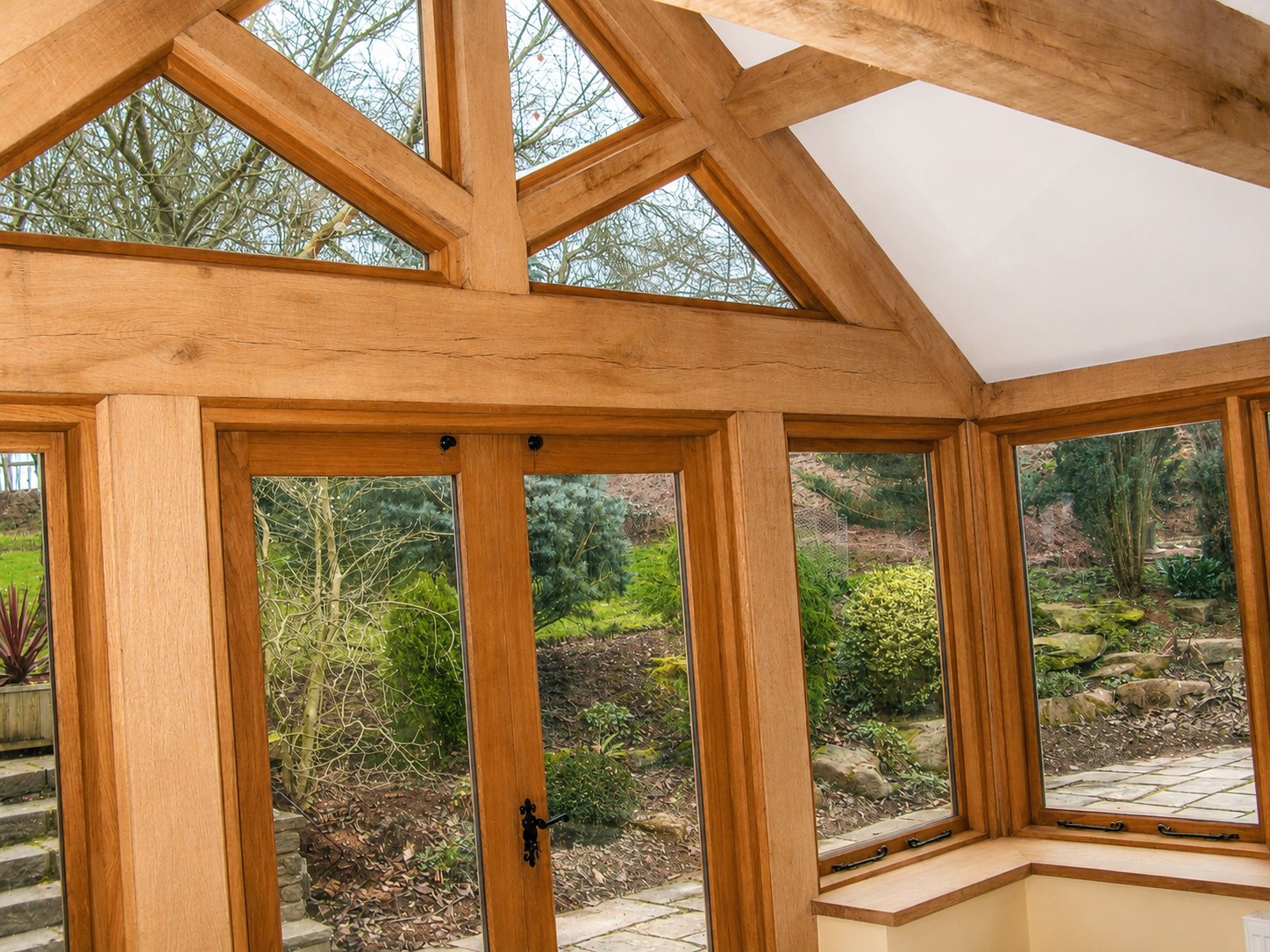 Timber garden-room doors and gabled roof structure