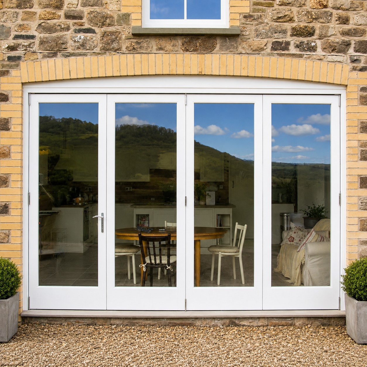 White glazed double doors in a stone wall