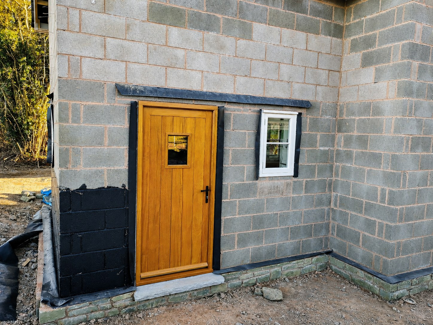 Timber entrance door and sidelight during building work