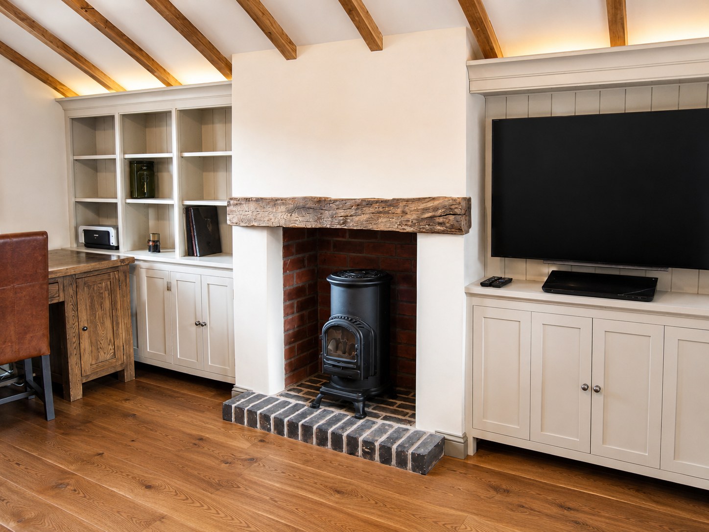 Painted cabinets and bookshelves beside a fireplace