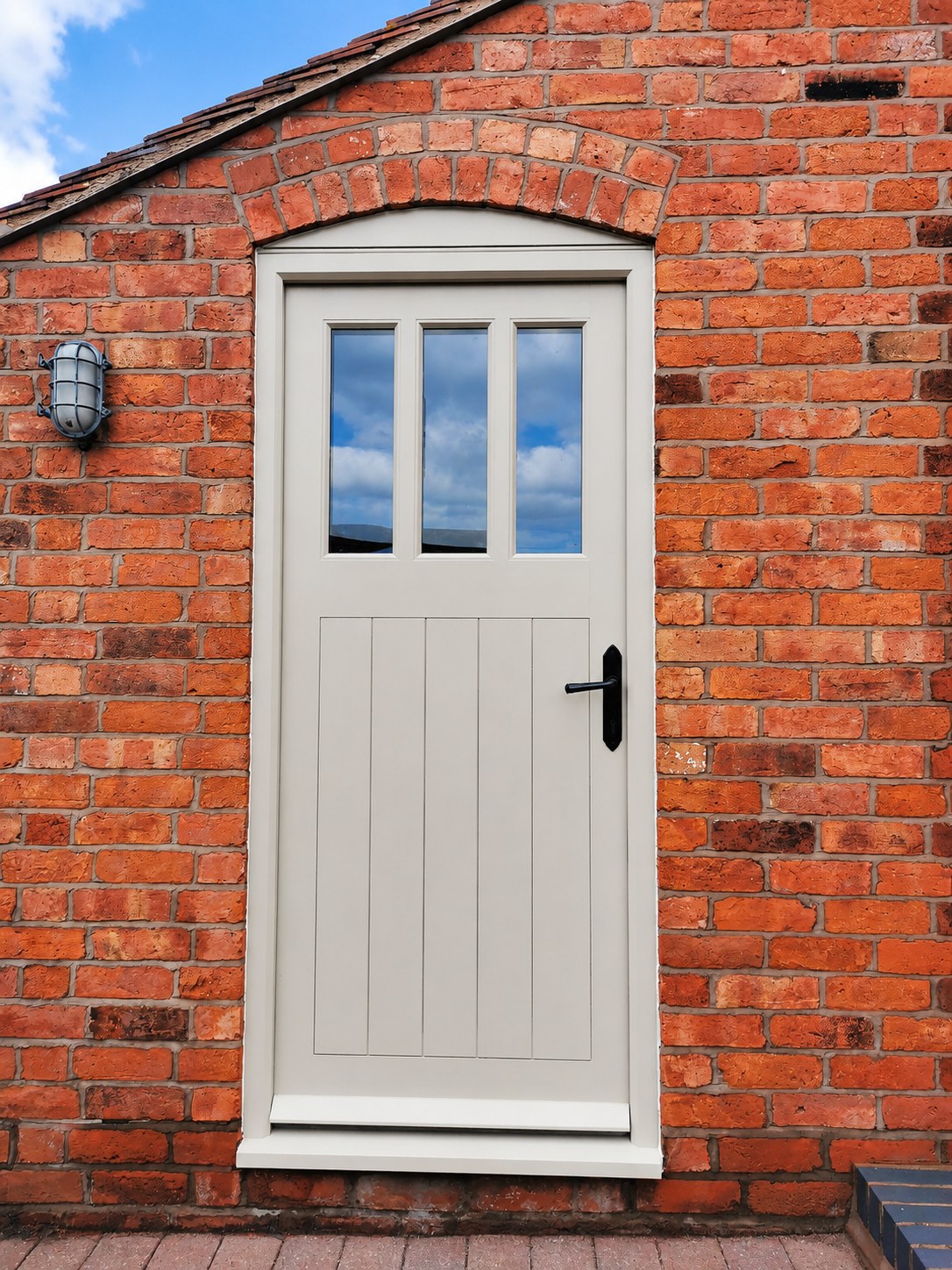 Pale painted entrance door with glazed upper panels