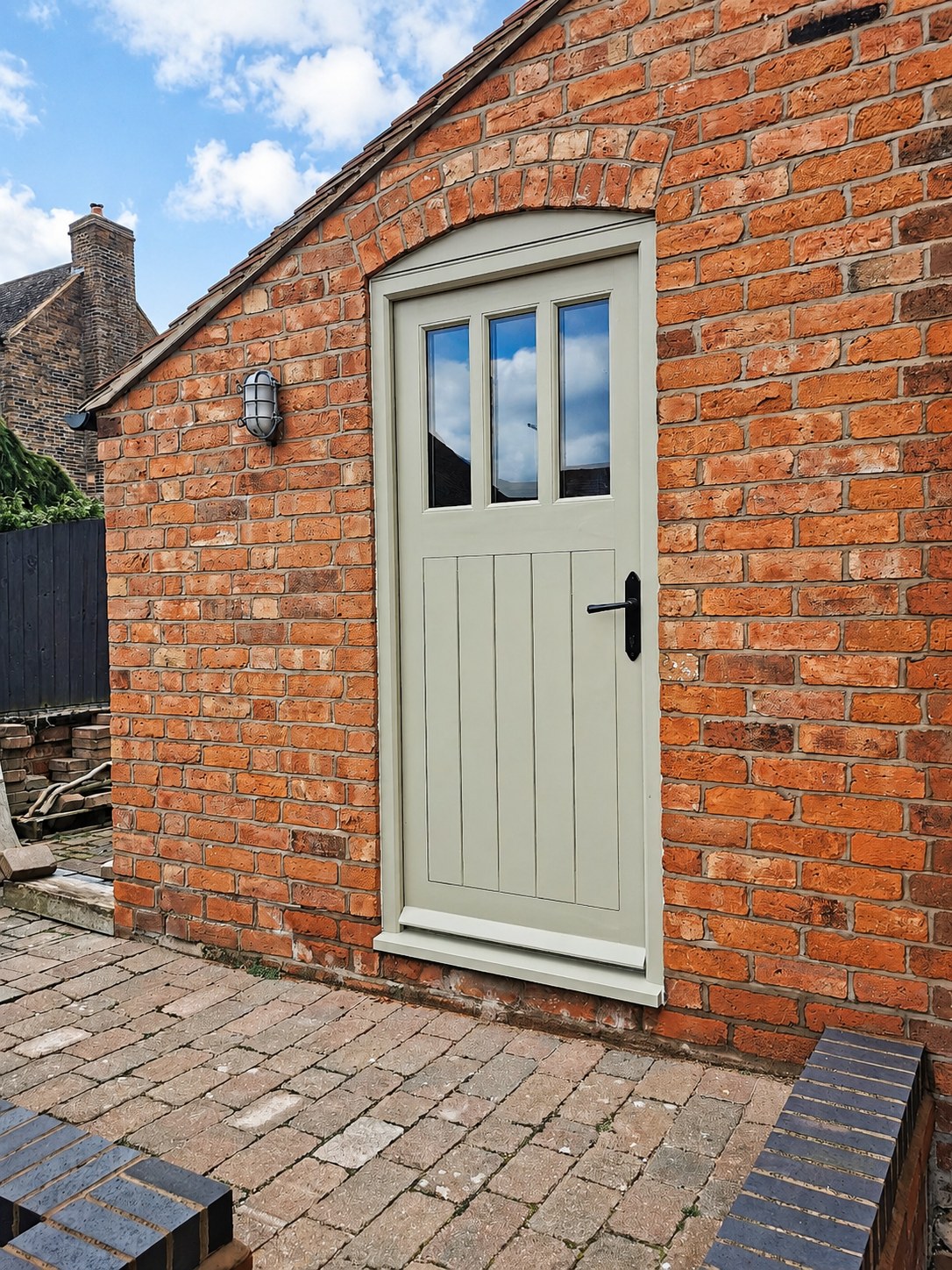 Pale painted entrance door in a brick wall