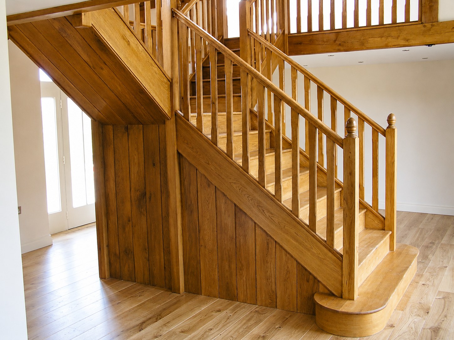 Timber staircase with a panelled enclosure below