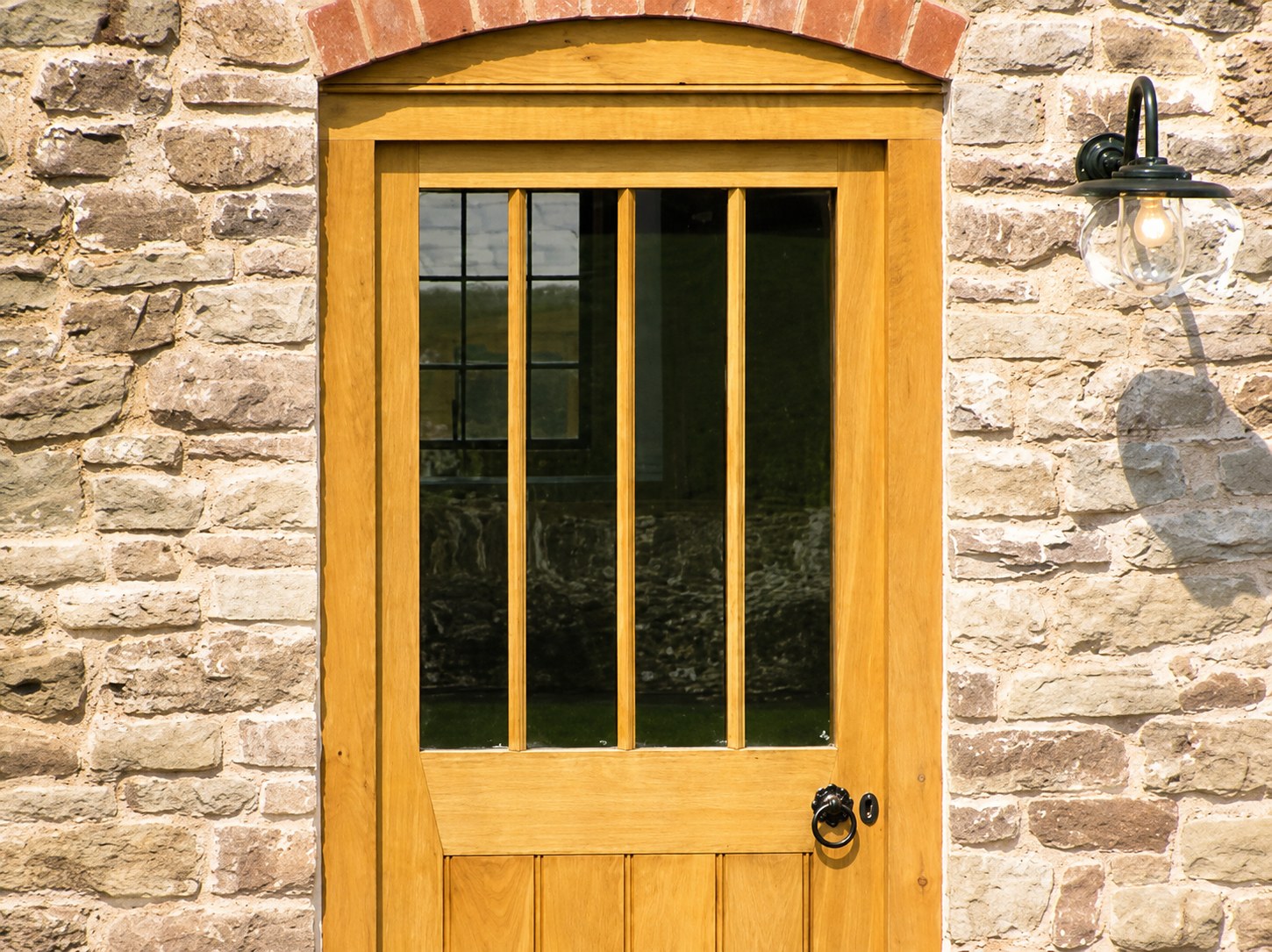 Glazed timber door and frame in a stone opening