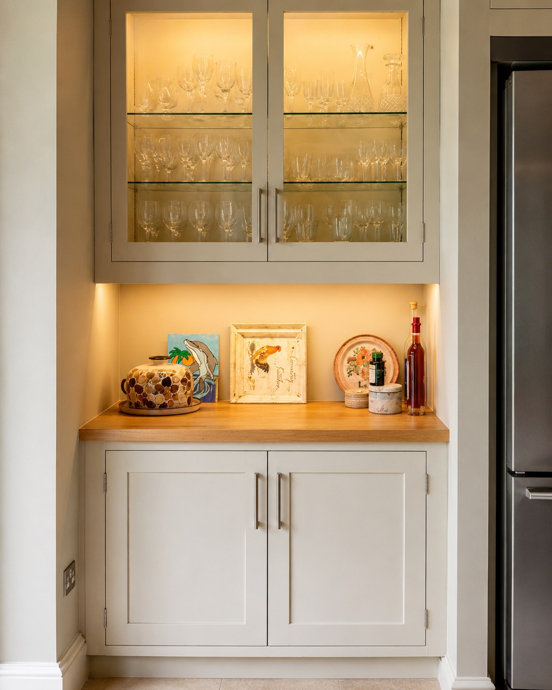 Painted cabinet with glazed upper doors and timber worktop