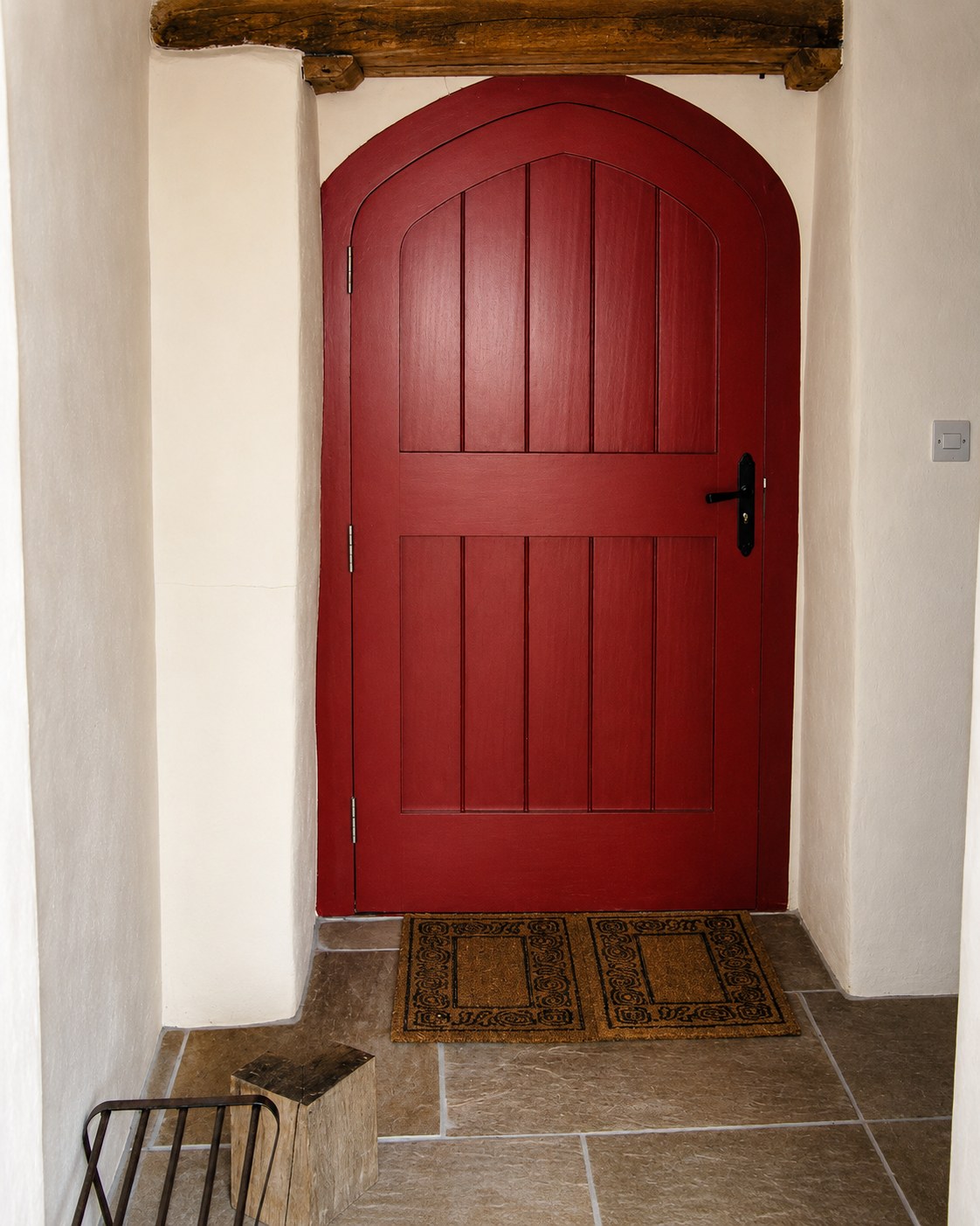 Arched red-painted internal timber door