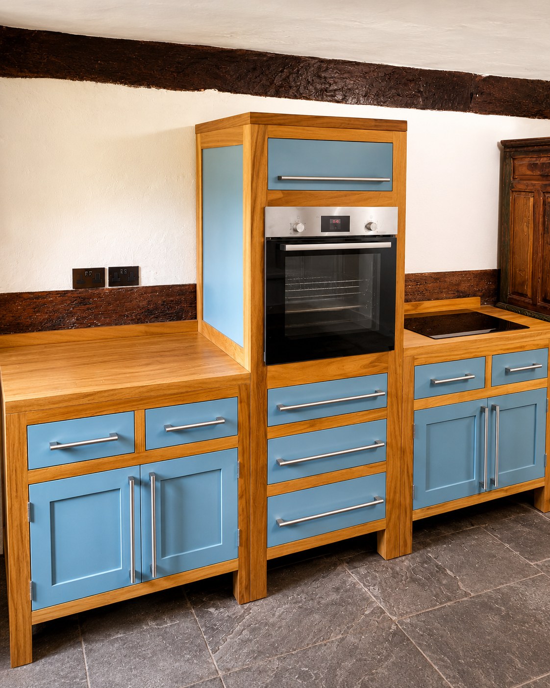 Blue kitchen cabinetry fitted around an oven