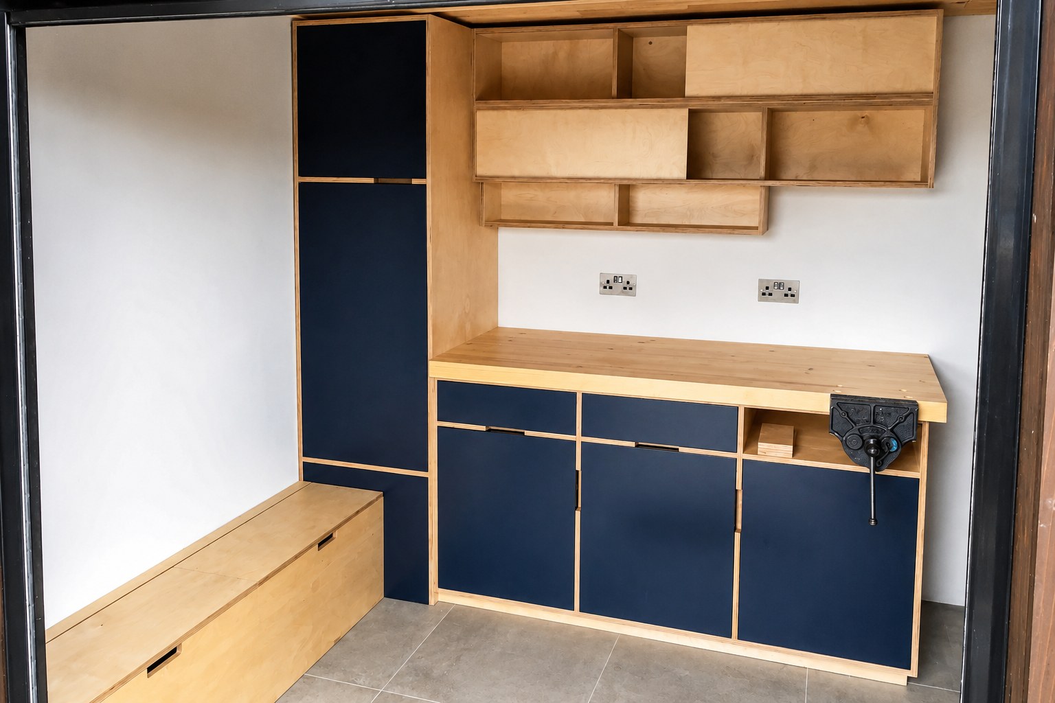 Dark fitted kitchen cabinets and open timber shelving