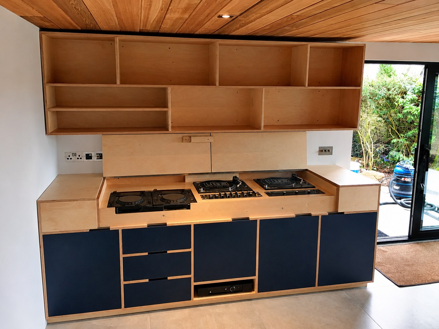 Kitchen cabinetry and open shelves before completion