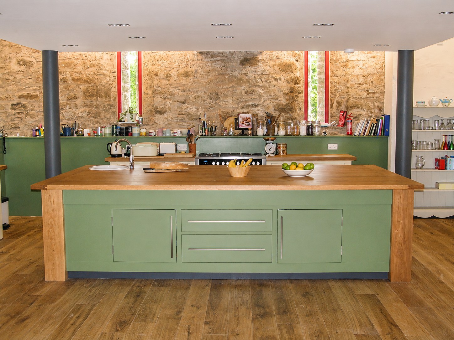Painted green kitchen island with timber worktop