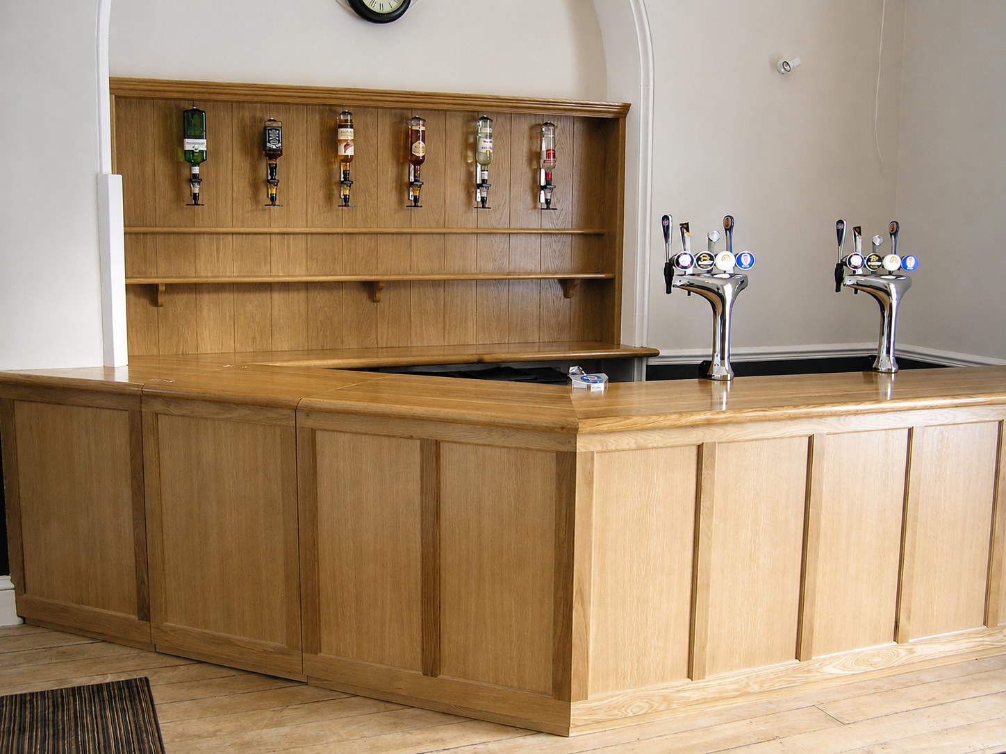 Timber bar counter with fitted shelving behind