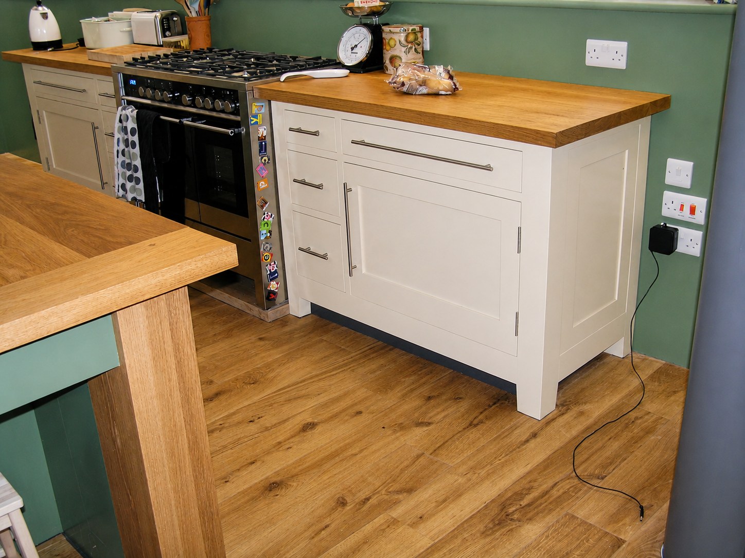 Painted kitchen units beside a cooker