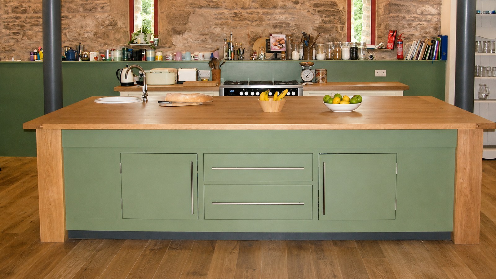 Green-painted kitchen island and timber worktop