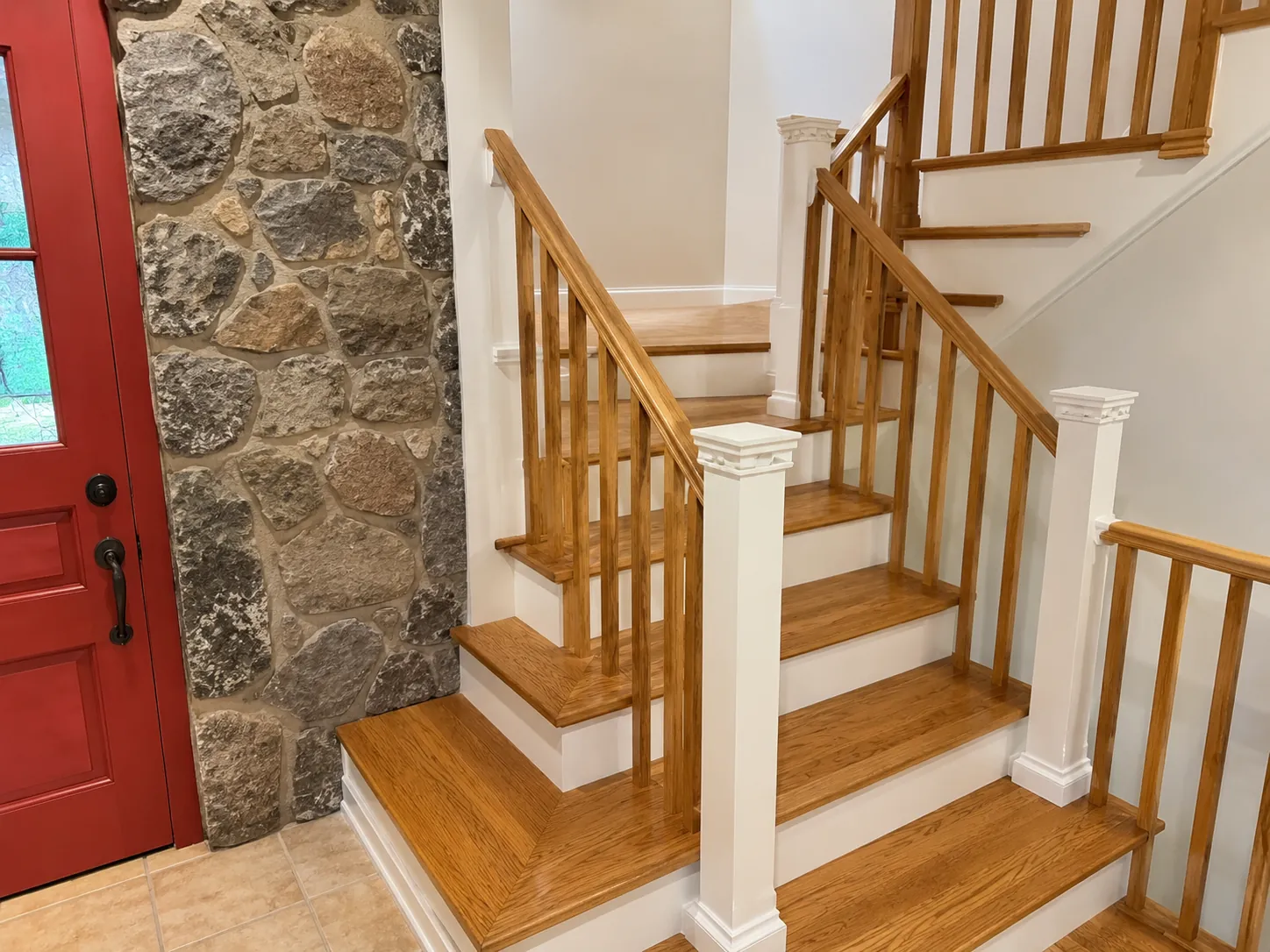 Timber staircase beside an exposed stone wall