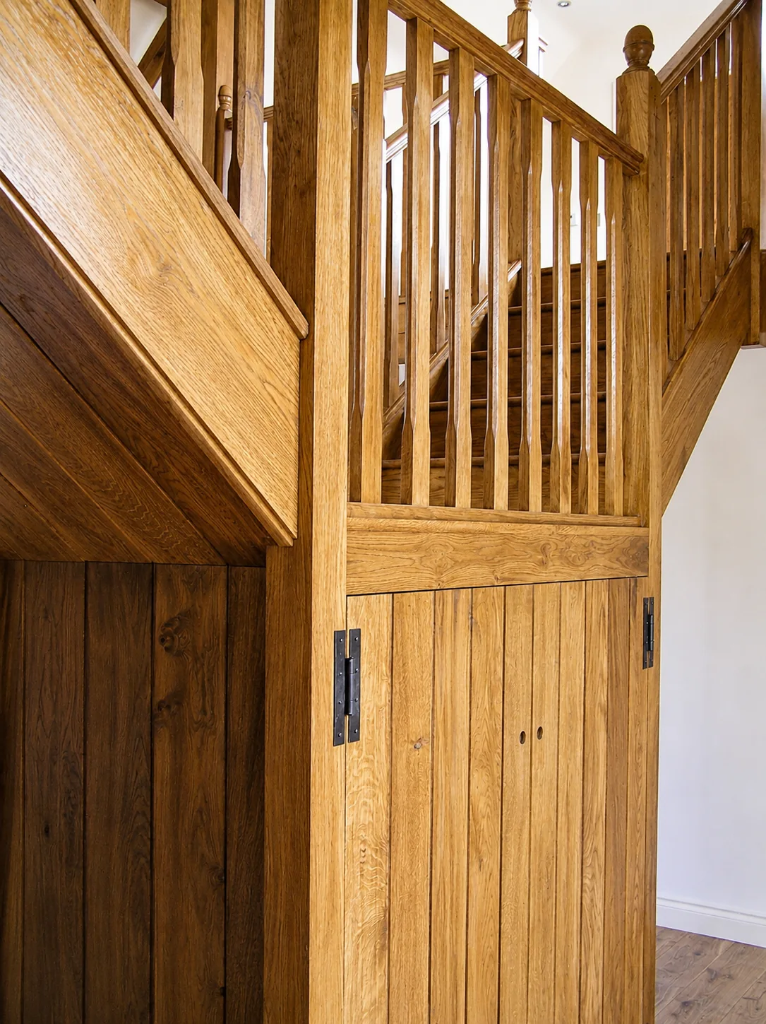 Panelled storage beneath a staircase