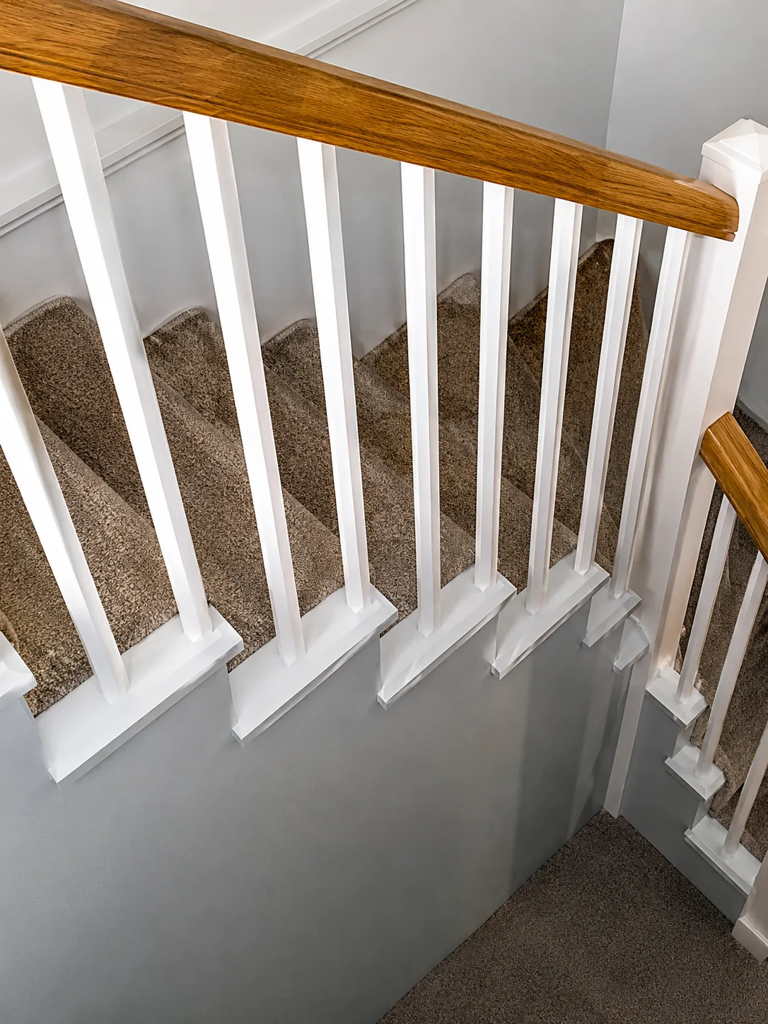 Timber handrail above painted balusters