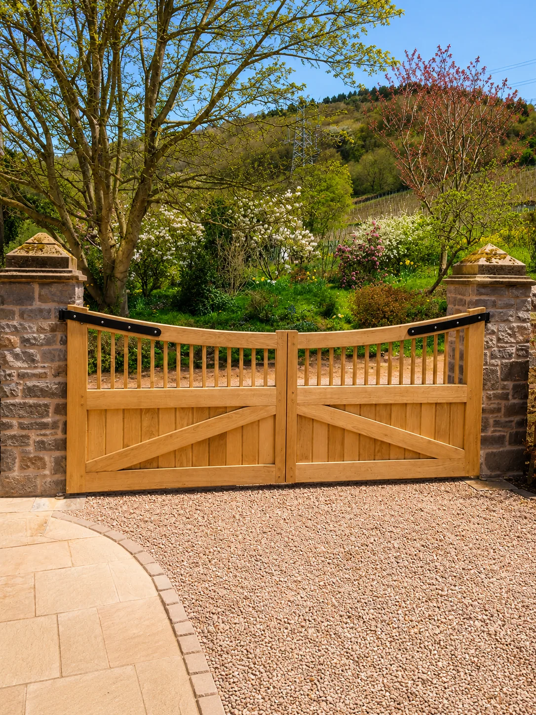 Timber driveway gates between stone posts