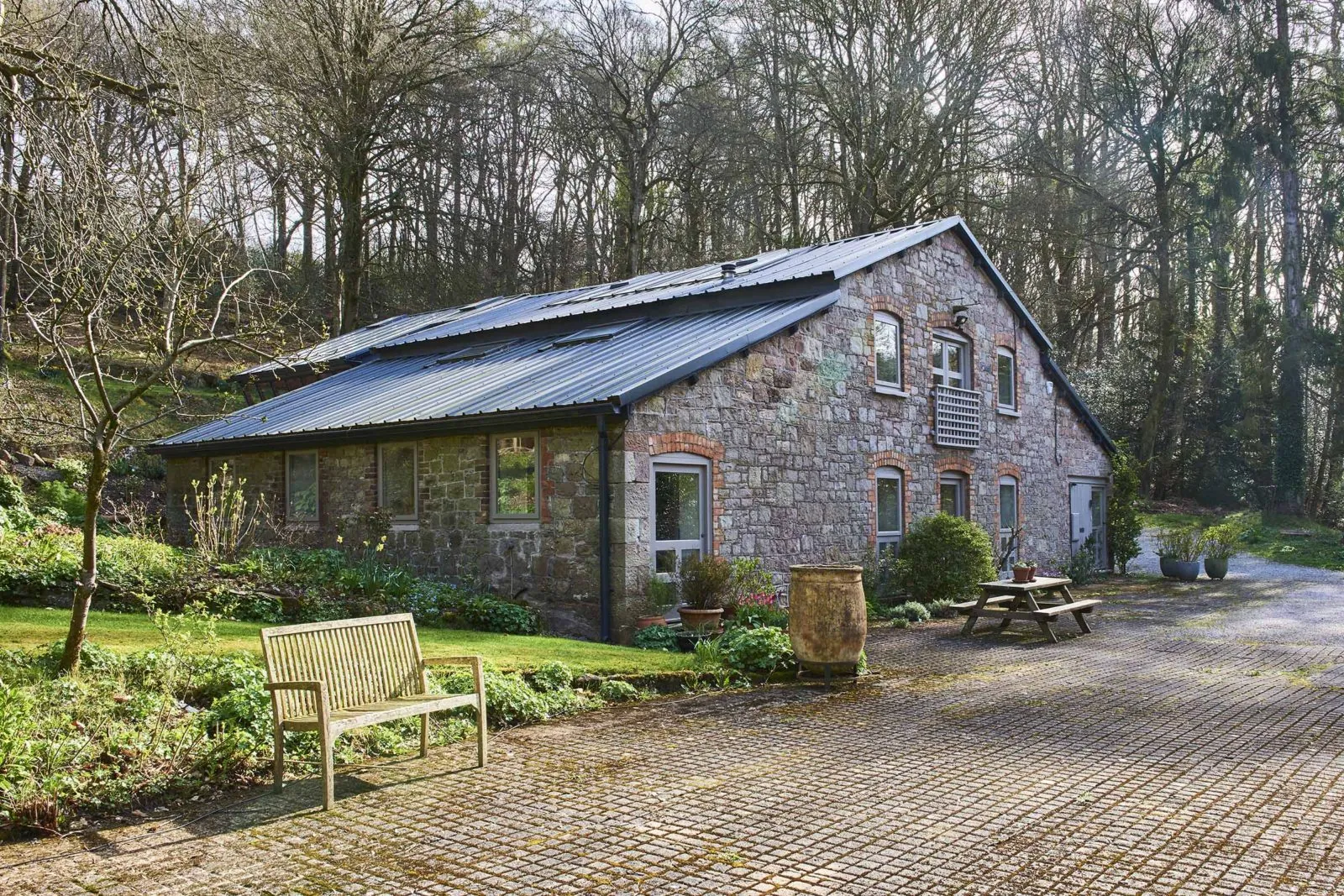 Stone garden building with a glazed extension