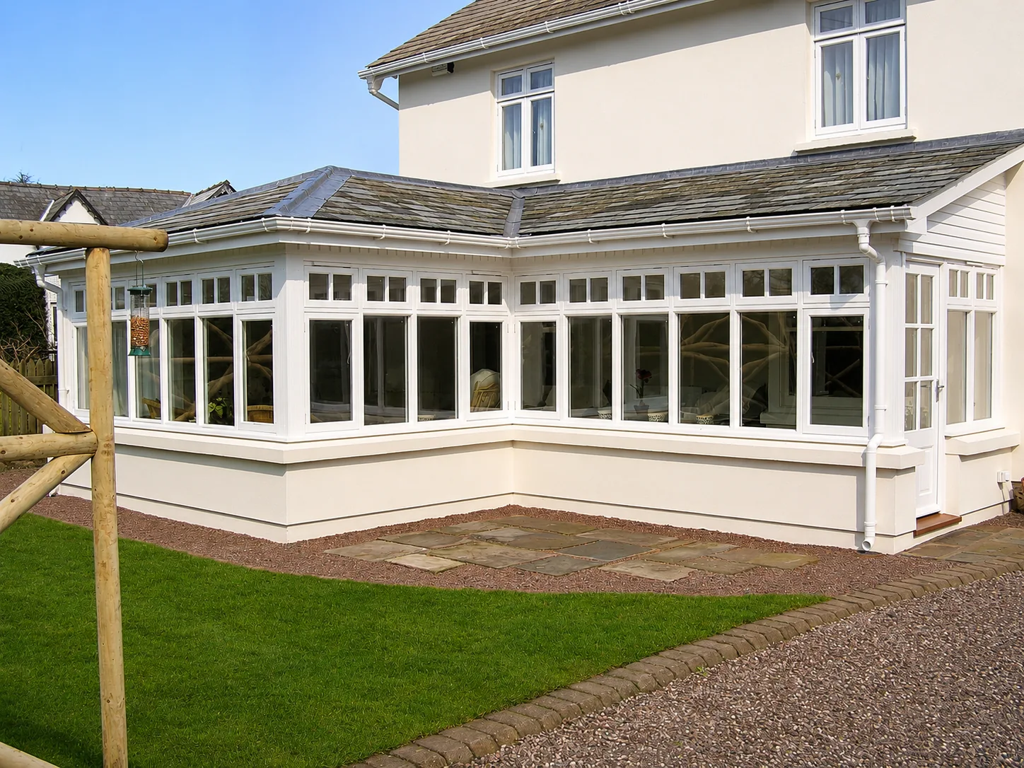 White garden-room windows and doors