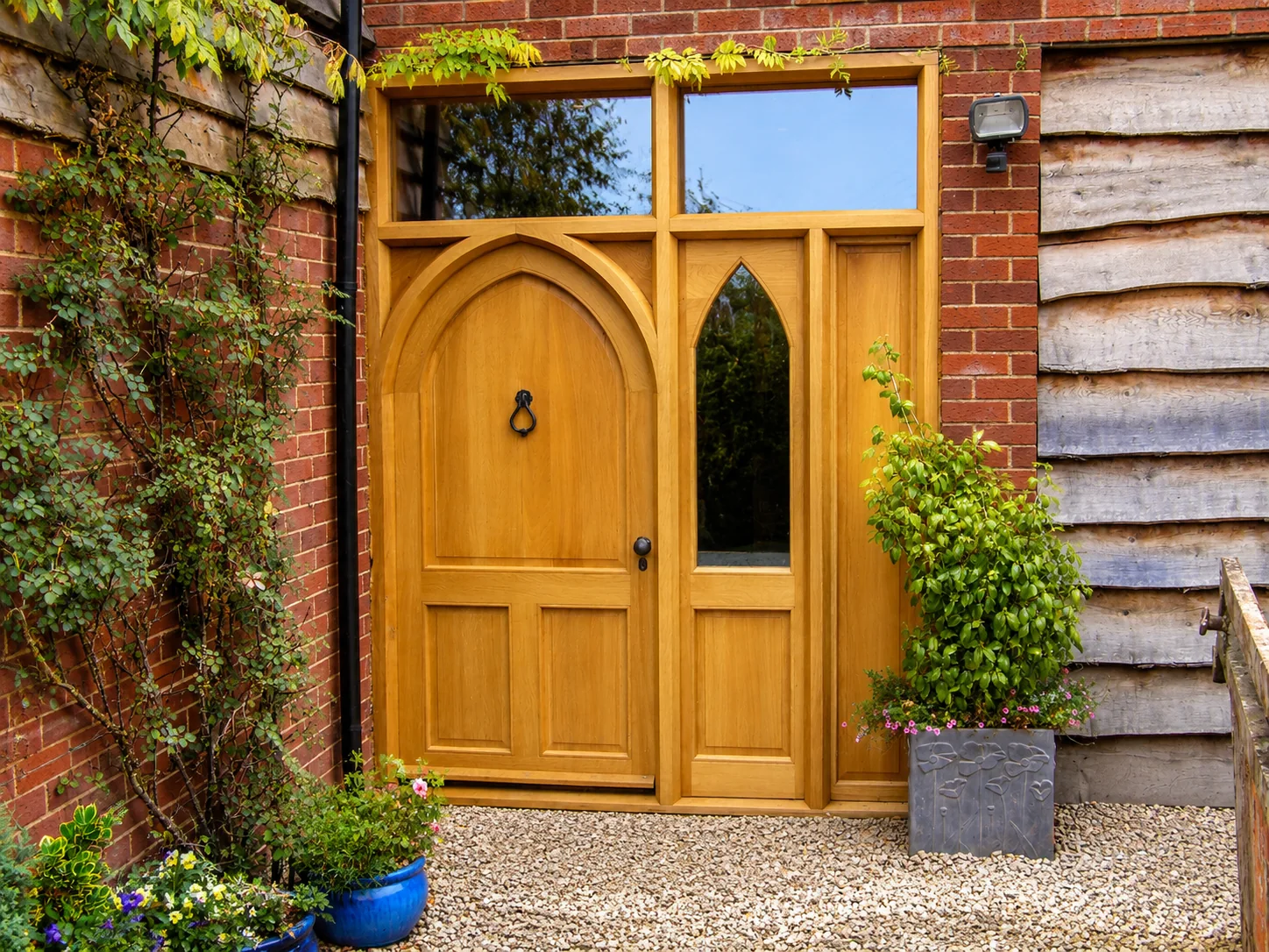 Arched timber door with surrounding glazing