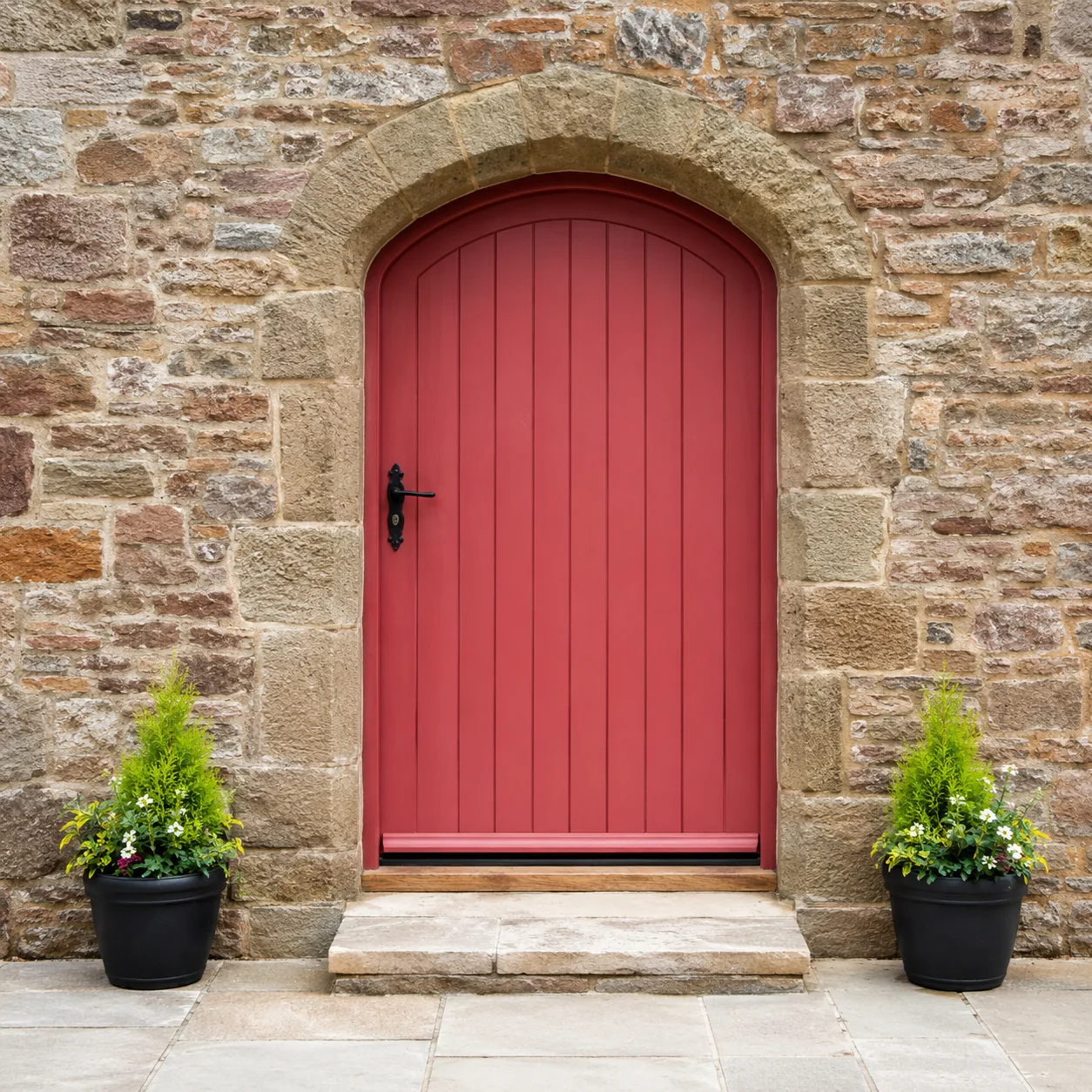 Red painted arched door in stone