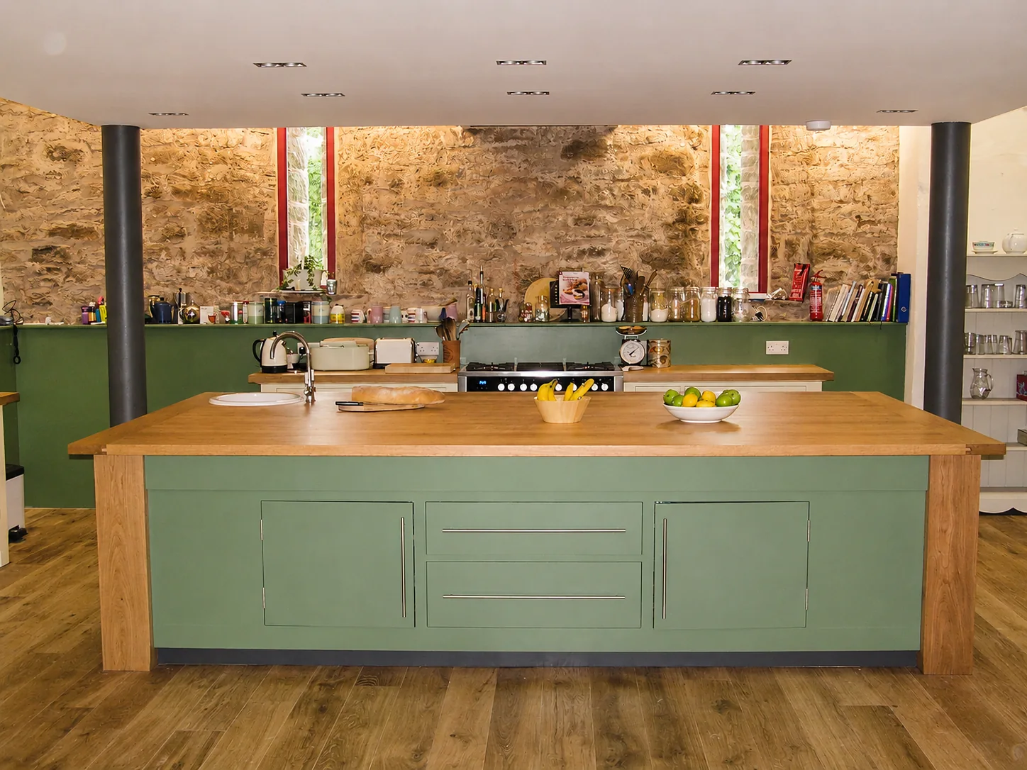 Green kitchen island with timber worktop