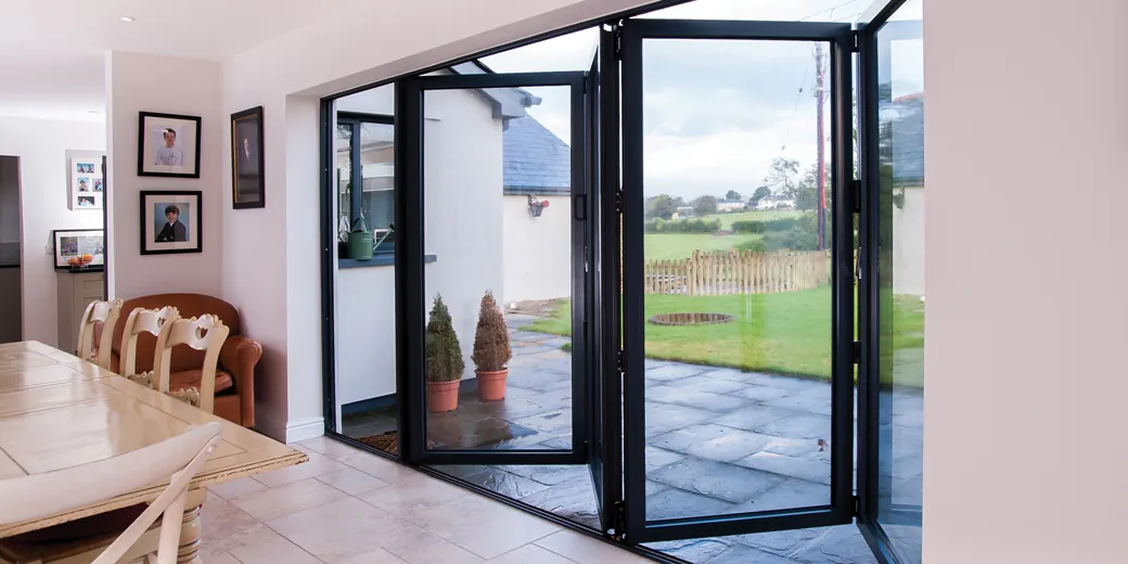 Glazed folding doors beside a dining area