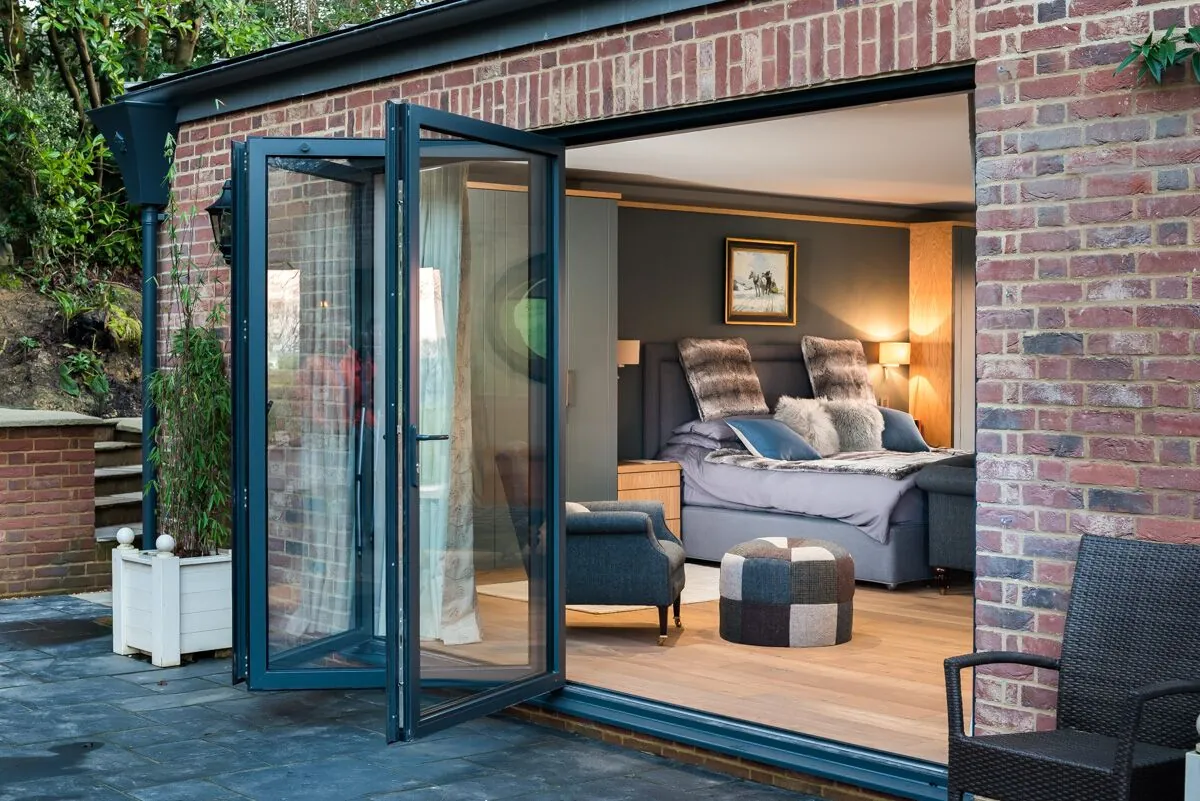 Open aluminium folding doors in a brick elevation