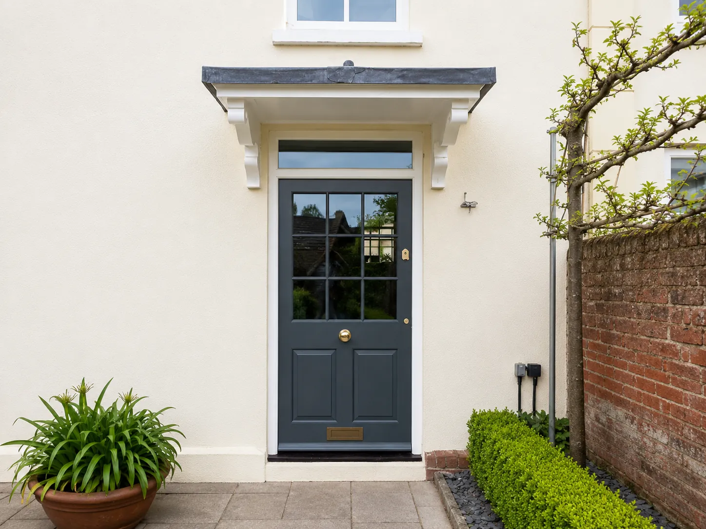 Grey painted entrance door in a white surround