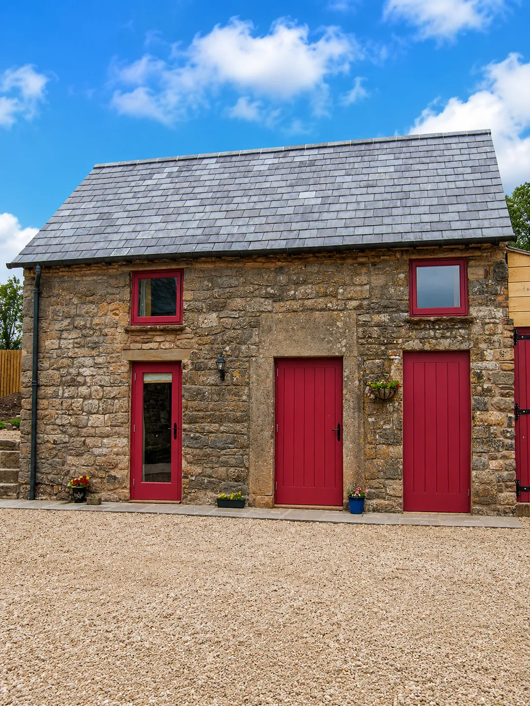Red painted doors and windows in a stone outbuilding